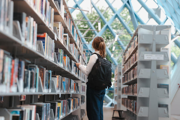 A person wearing a Spectron Synik 26 in a library